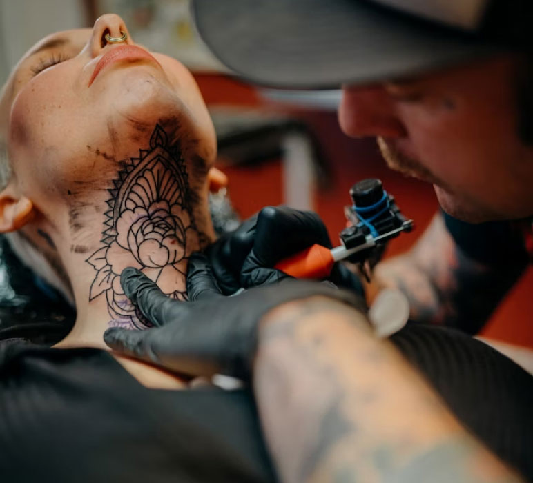 Person Getting a Tattoo in the Neck Person Getting a Tattoo in the Neck