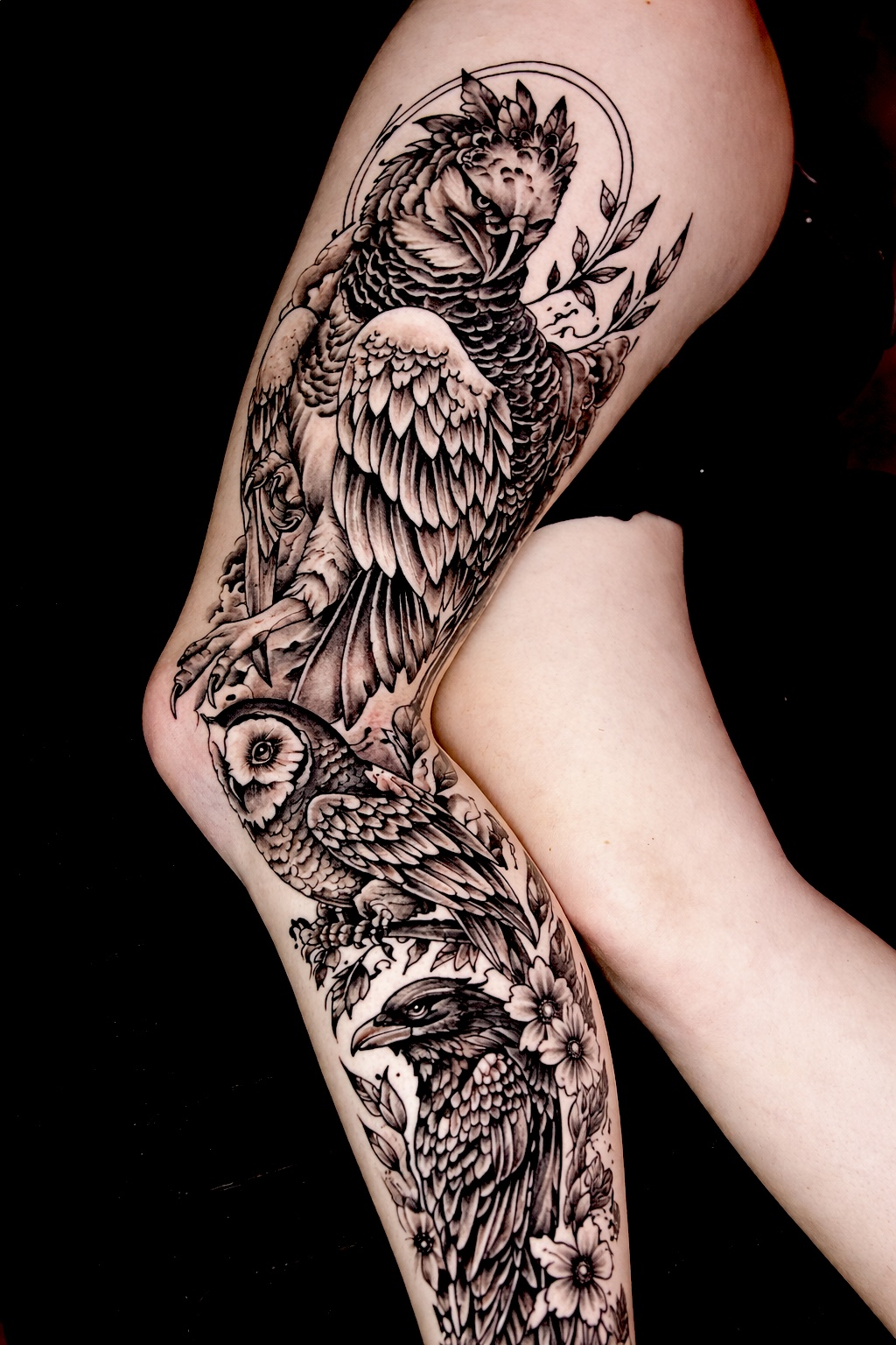 Realistic owl and bird tattoo on a leg