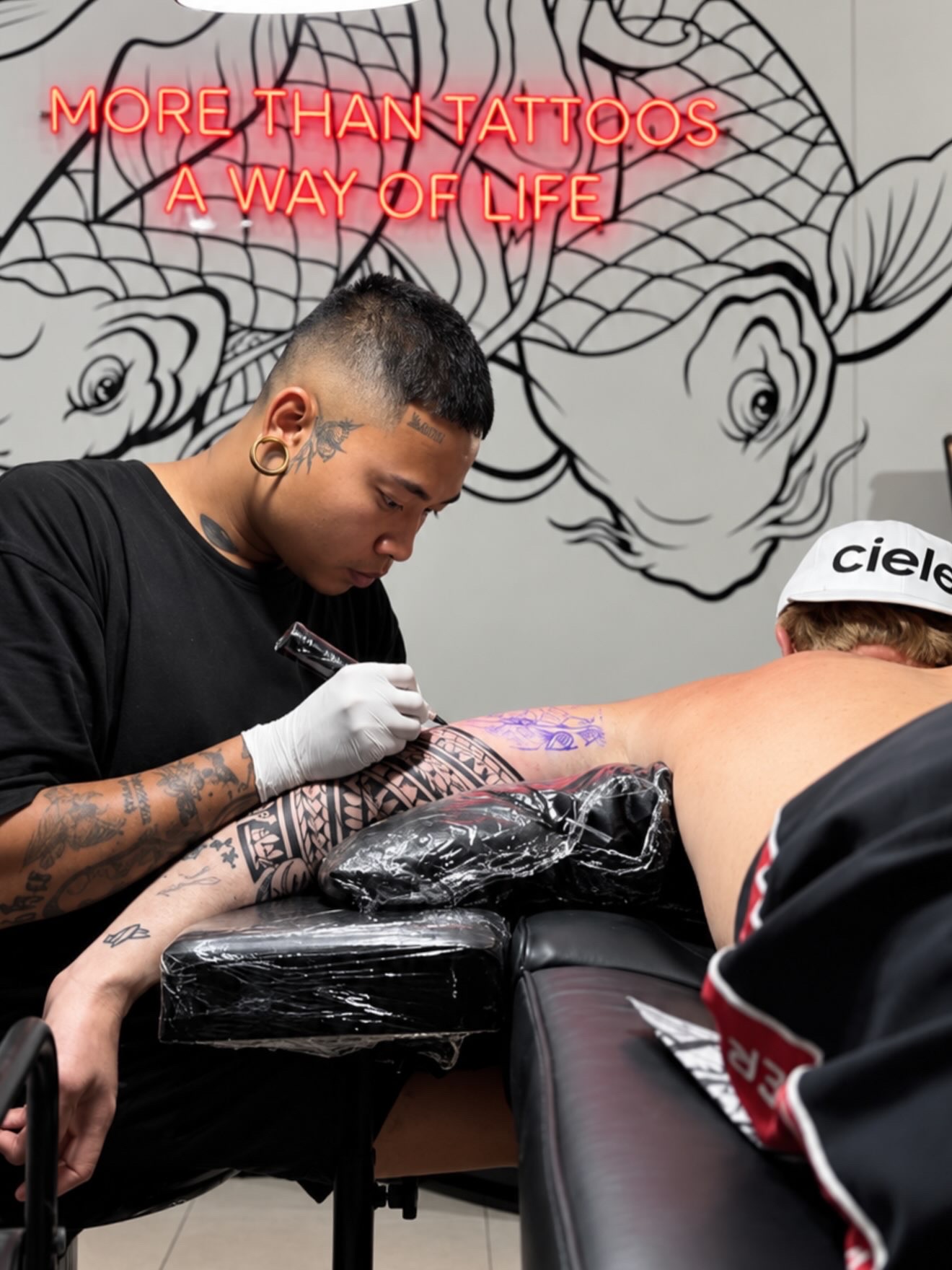 Black Koi Tattoo artist working in the studio in Kuta, Lombok